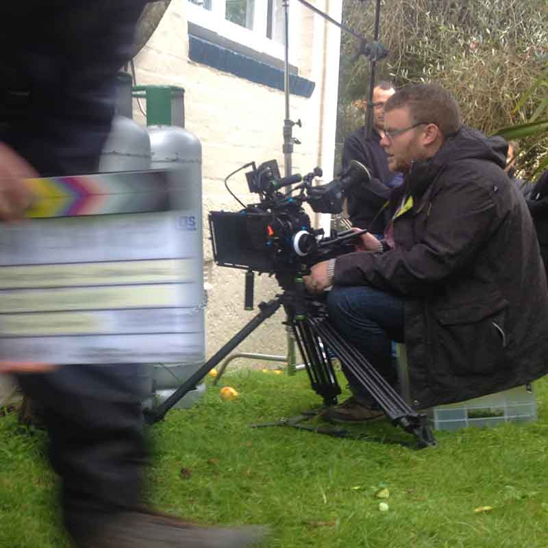 Jason Williamson operating a video camera