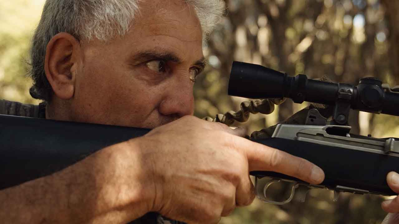 person holding a hunting rifle