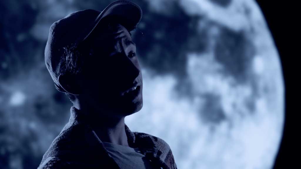 person singing silhouette against the moon