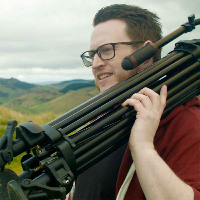 Chris McDonald holding a tripod