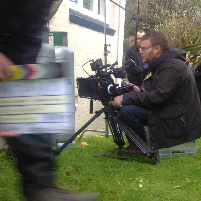 Jason Williamson operating a video camera